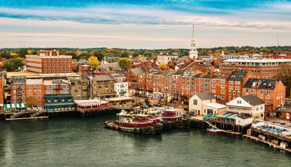 Aerial view of Downtown Portsmouth, New Hampshire, showcasing historic buildings and boats on water during fall